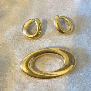 Vintage gold tone swirl oval brooch and earrings.